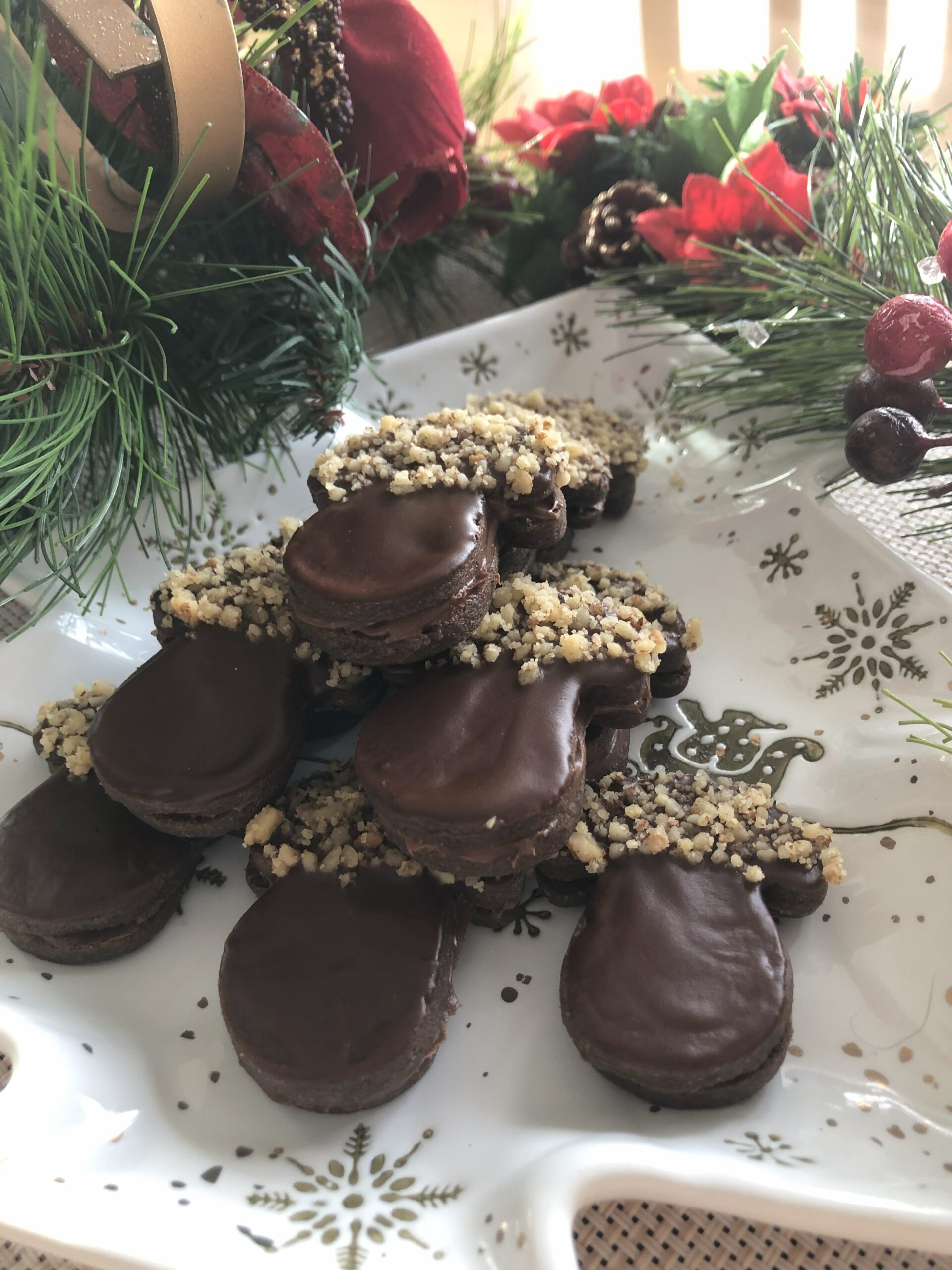 Mushroom Cookies with Nutella Filling displayed on Christmas decorated table.