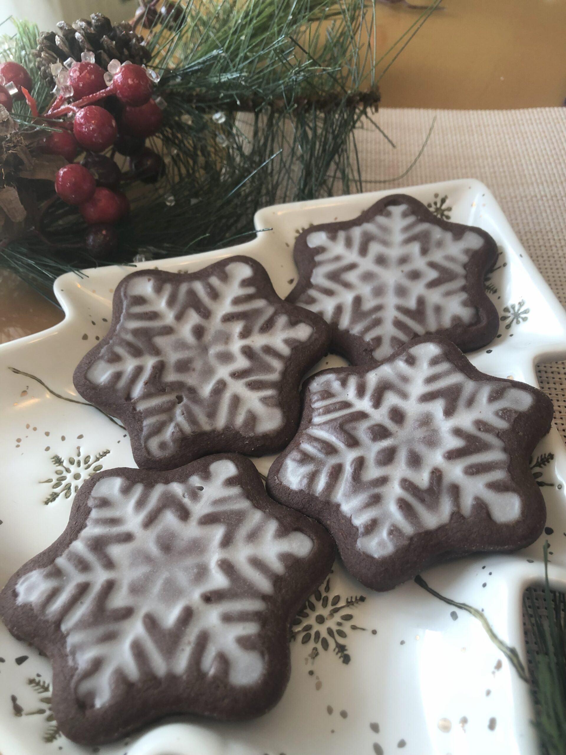 Mocha Glazed Snowflake Cookies on festive table.