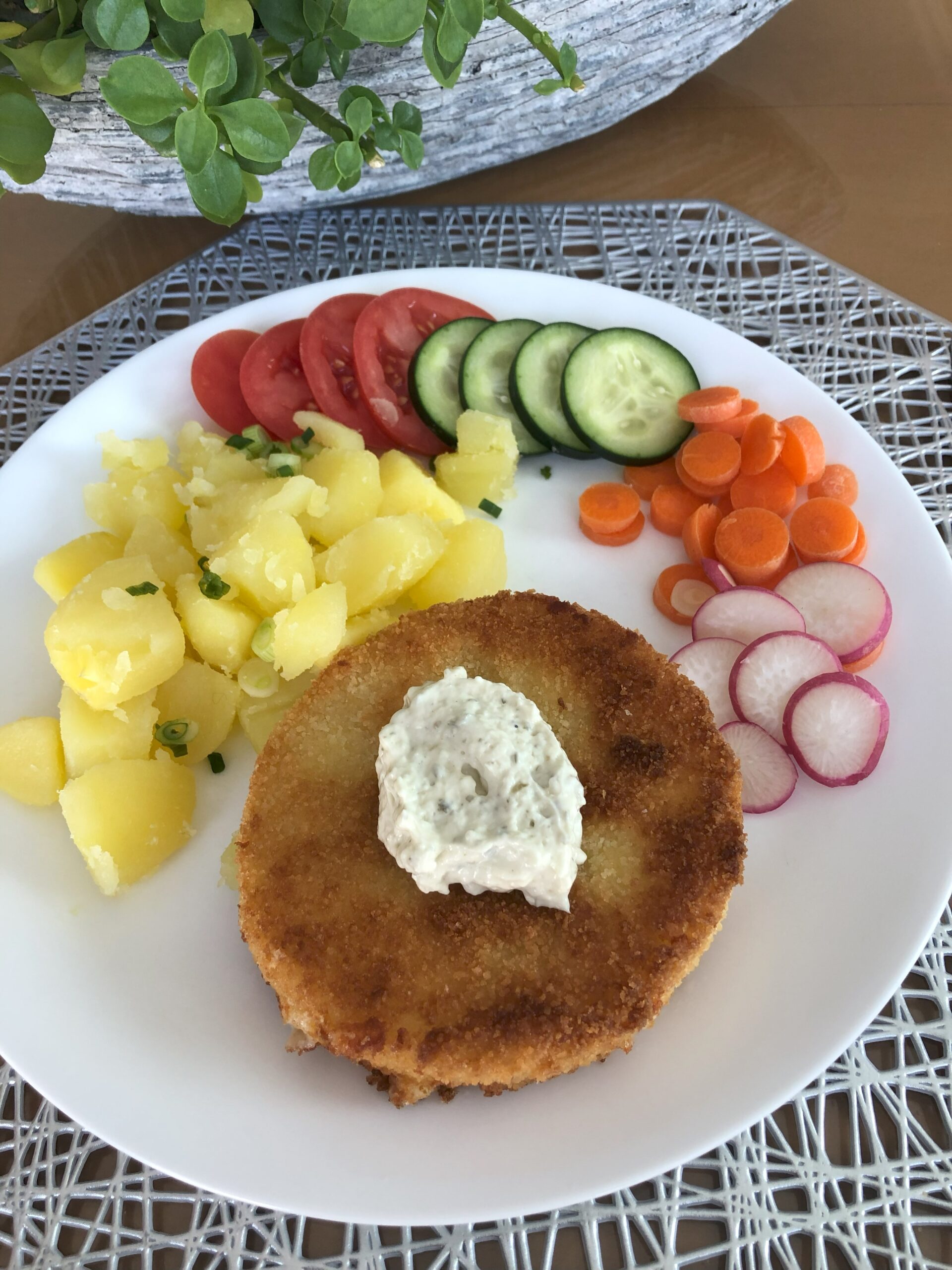 Fried Cheese on a plate with potatoes and Tartar sauce.