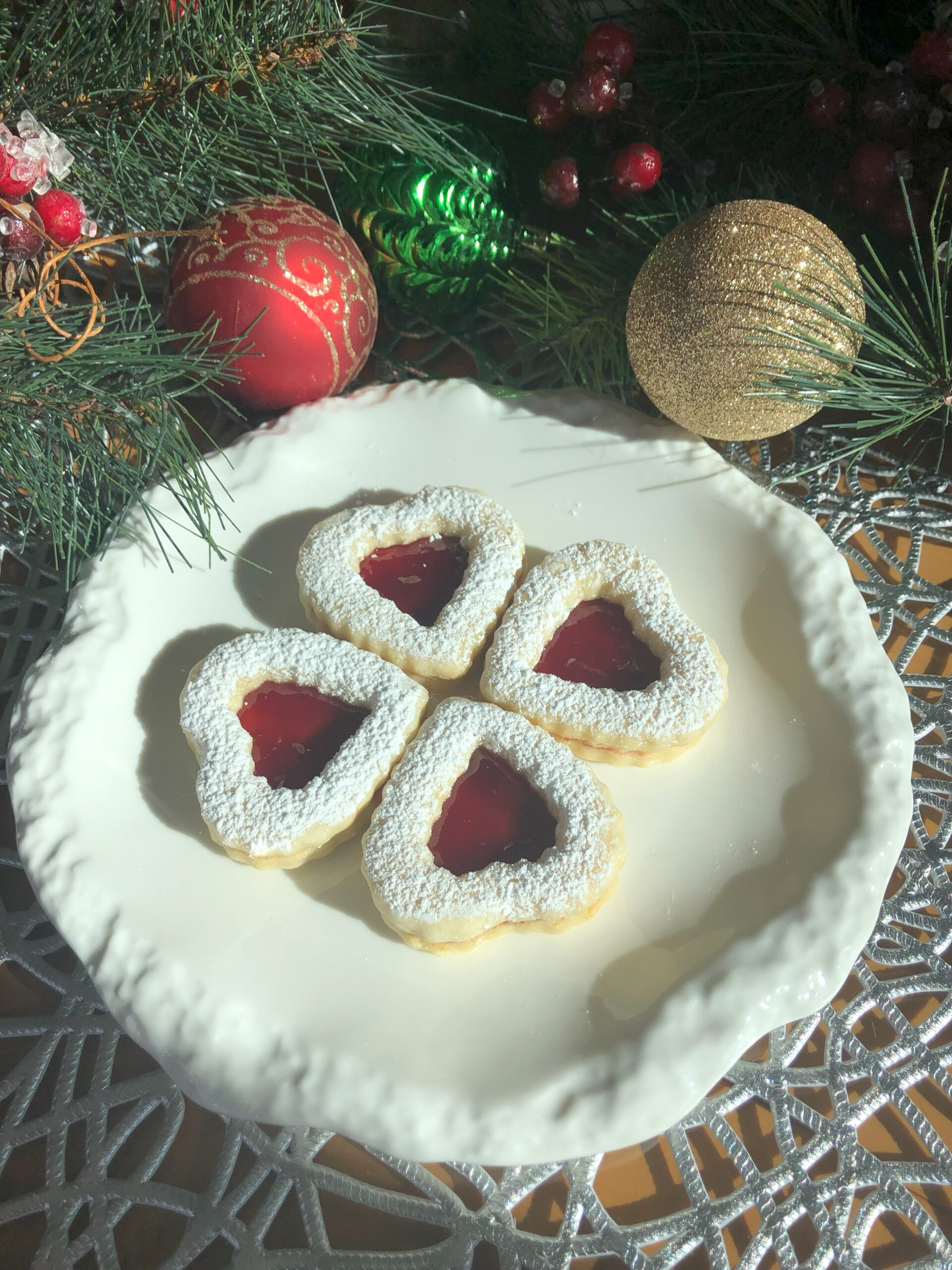 Linzer cookies on the Christmas decorated table.