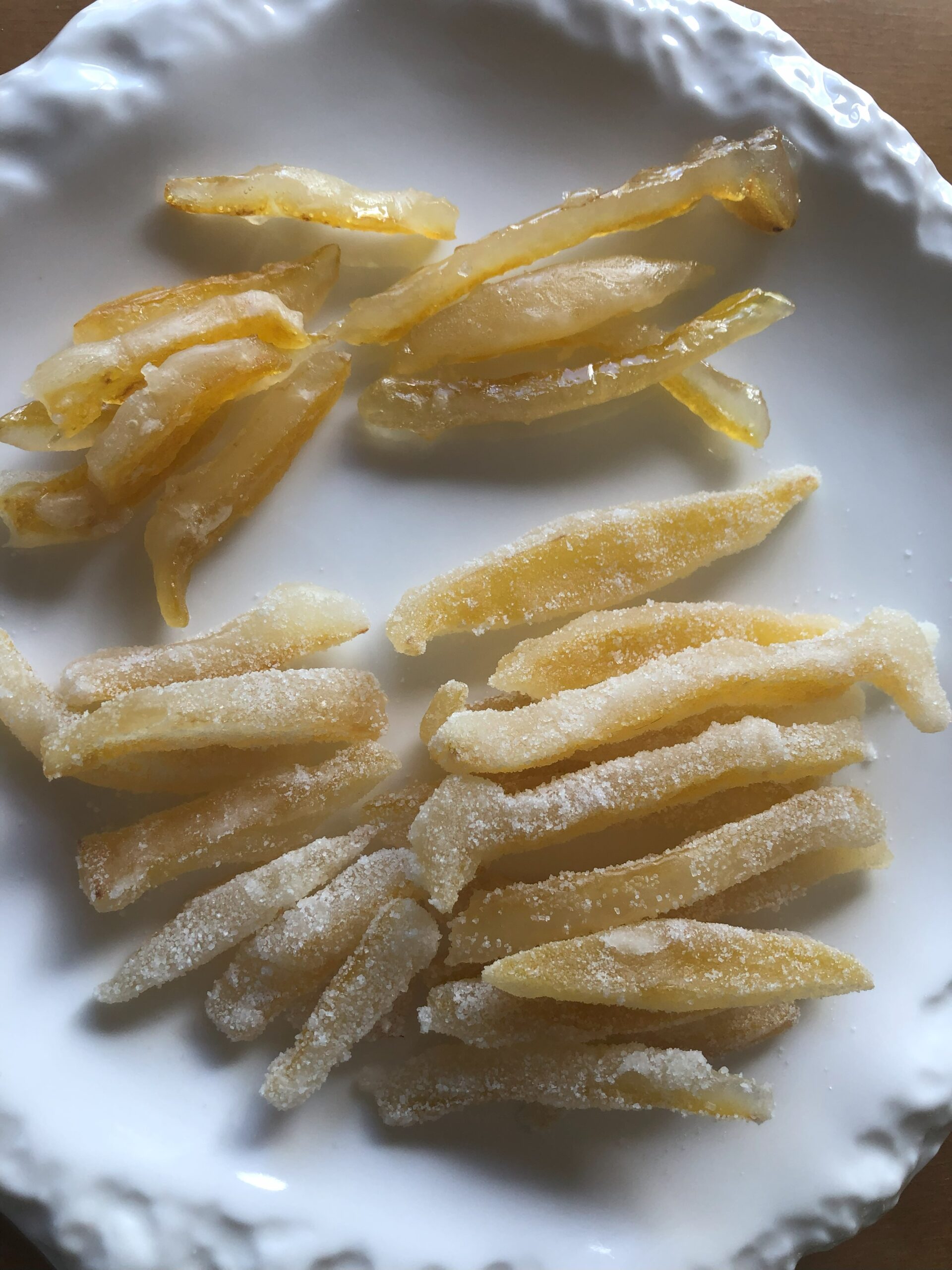 Candied Lemon Zest displayed on a plate on the table.