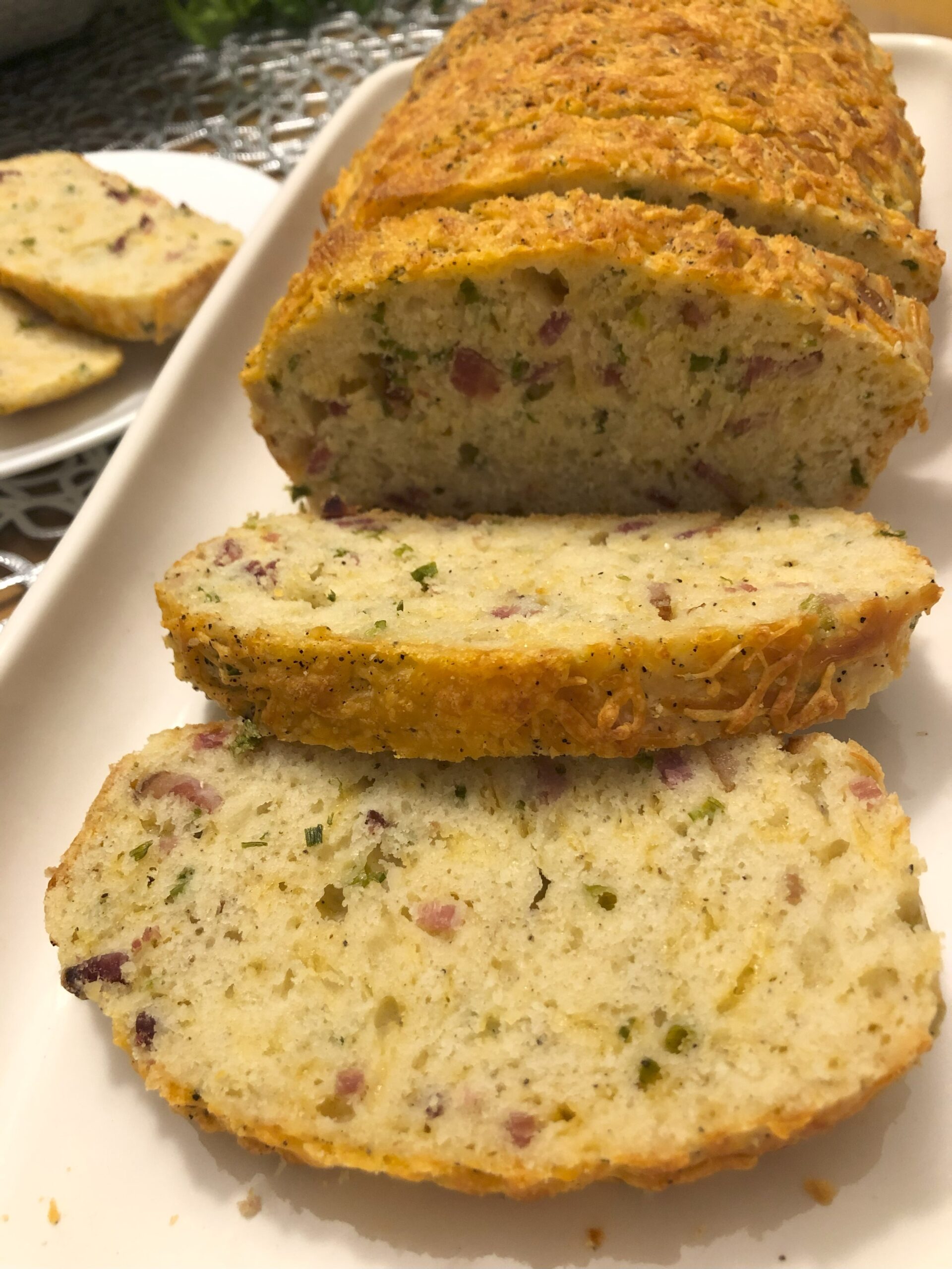 Sliced Bacon and Cheese Quick bread displayed on a plate.