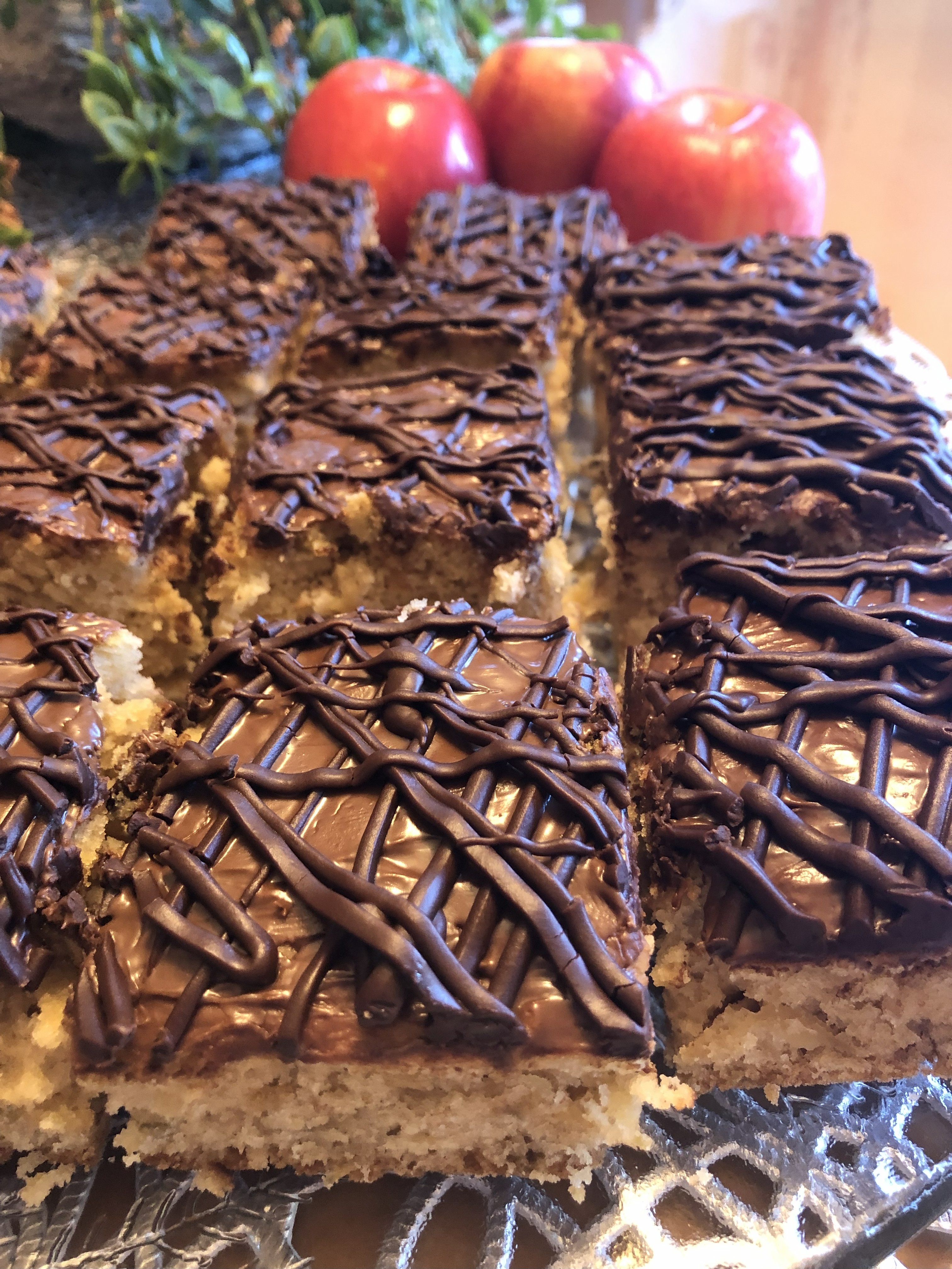 Displayed cut up sheet cake with Nutella and Apples.